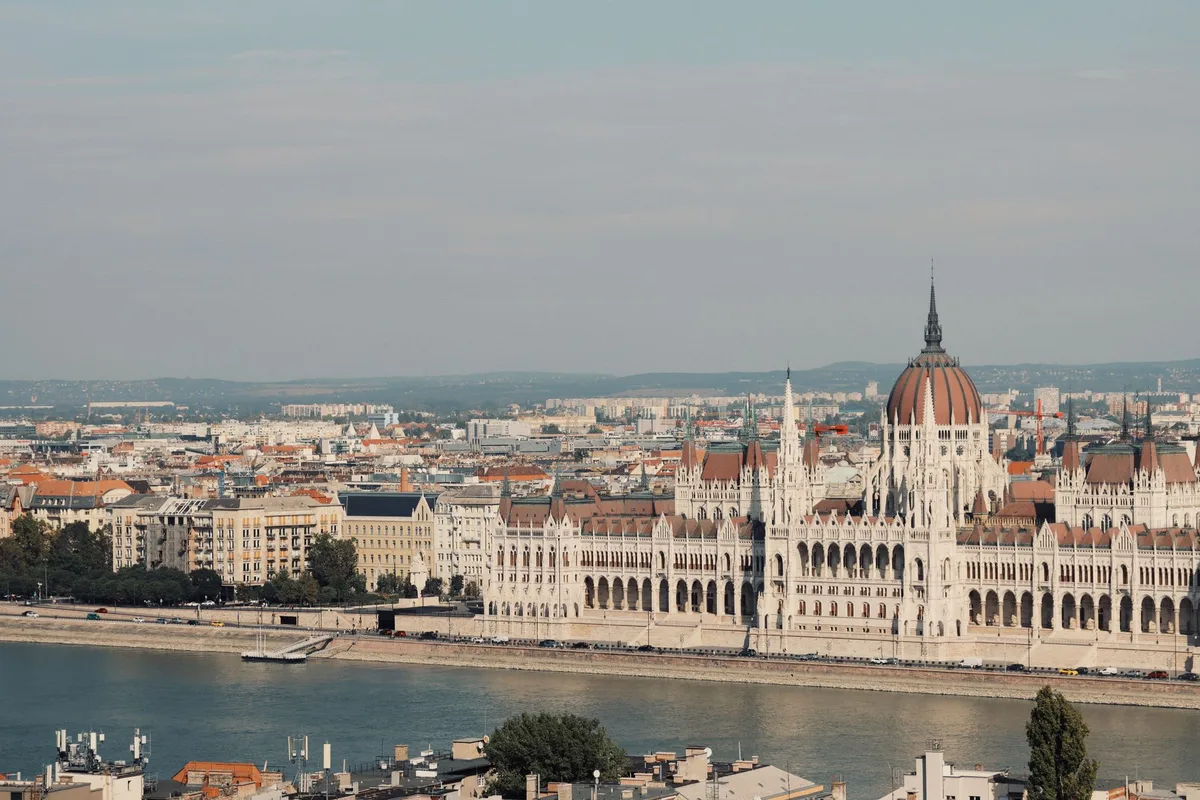 Film production set in Budapest with movie equipment, crew members, and dramatic lighting reflecting the scale of a major action thriller production in progress