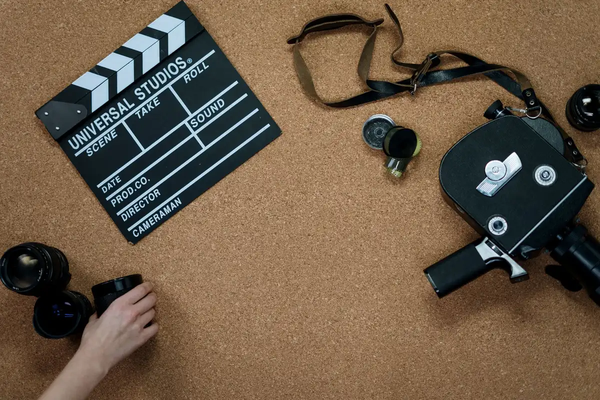 A close-up of action movie filming equipment and cameras on a professional set with dramatic shadows and industrial lighting