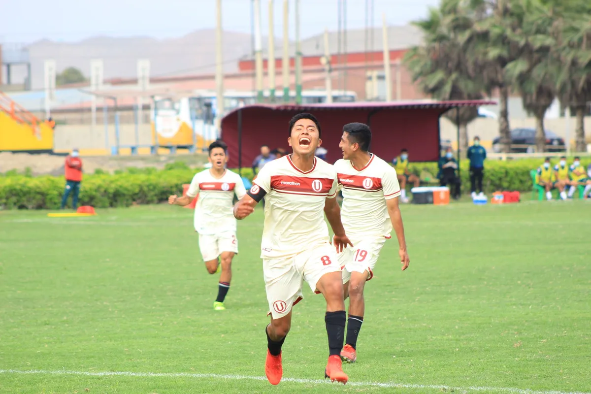 Flamengo players celebrating a goal in the stadium, arms raised, blurred crowd in background, joy and momentum captured