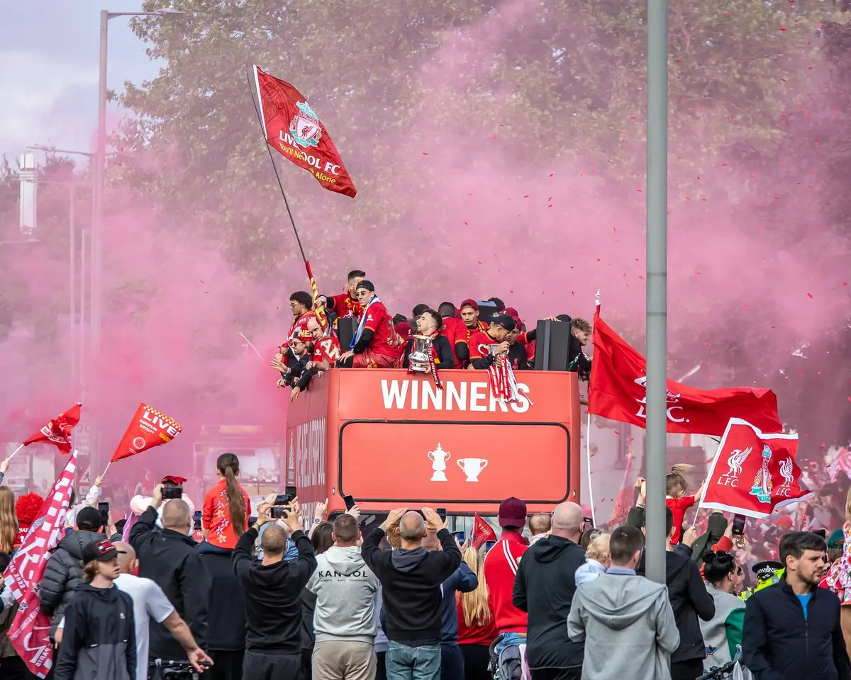 Confetti and celebratory atmosphere suspended in motion above an empty victory podium, spotlight beam cutting through evening air, stage decorated with symbolic elements of hip-hop culture