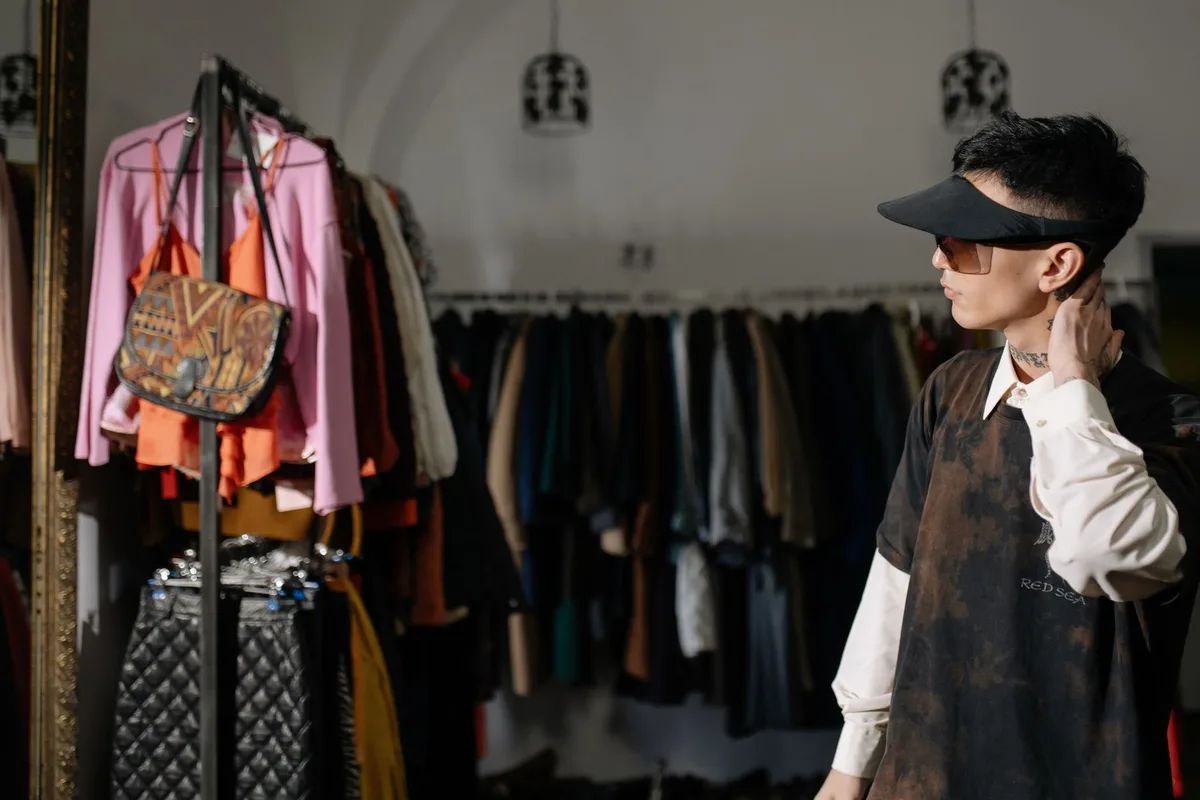 A pillbox hat displayed on a vintage-inspired dress form in a luxury boutique setting, surrounded by classic tailored fabrics and delicate vintage accessories, soft natural light streaming through windows