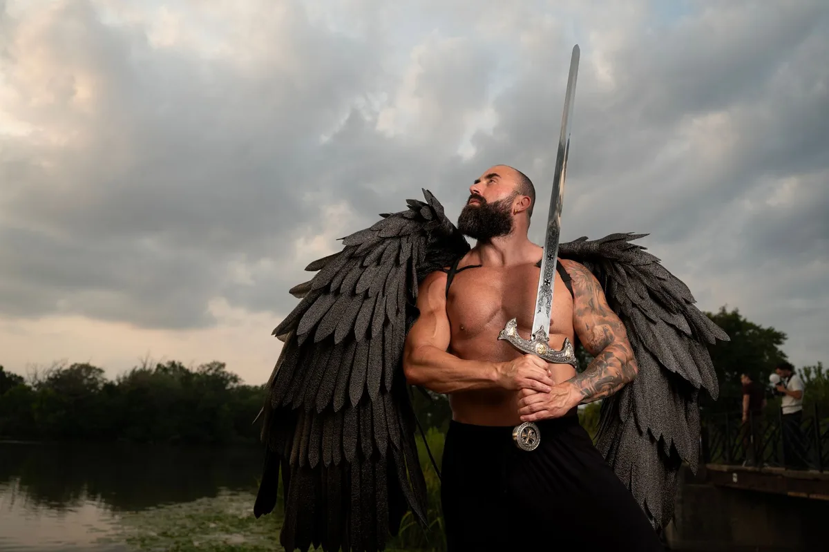 A muscular silhouette against a Norse-inspired backdrop with dramatic storm clouds and ancient stone architecture, weapon visible in shadow