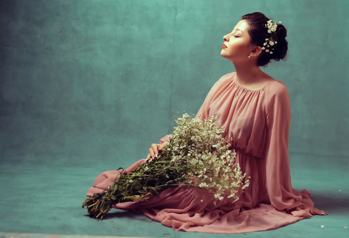 Actress in contemplative pose, soft lighting, intimate studio setting with ceramic pieces and natural textures, serene expression
