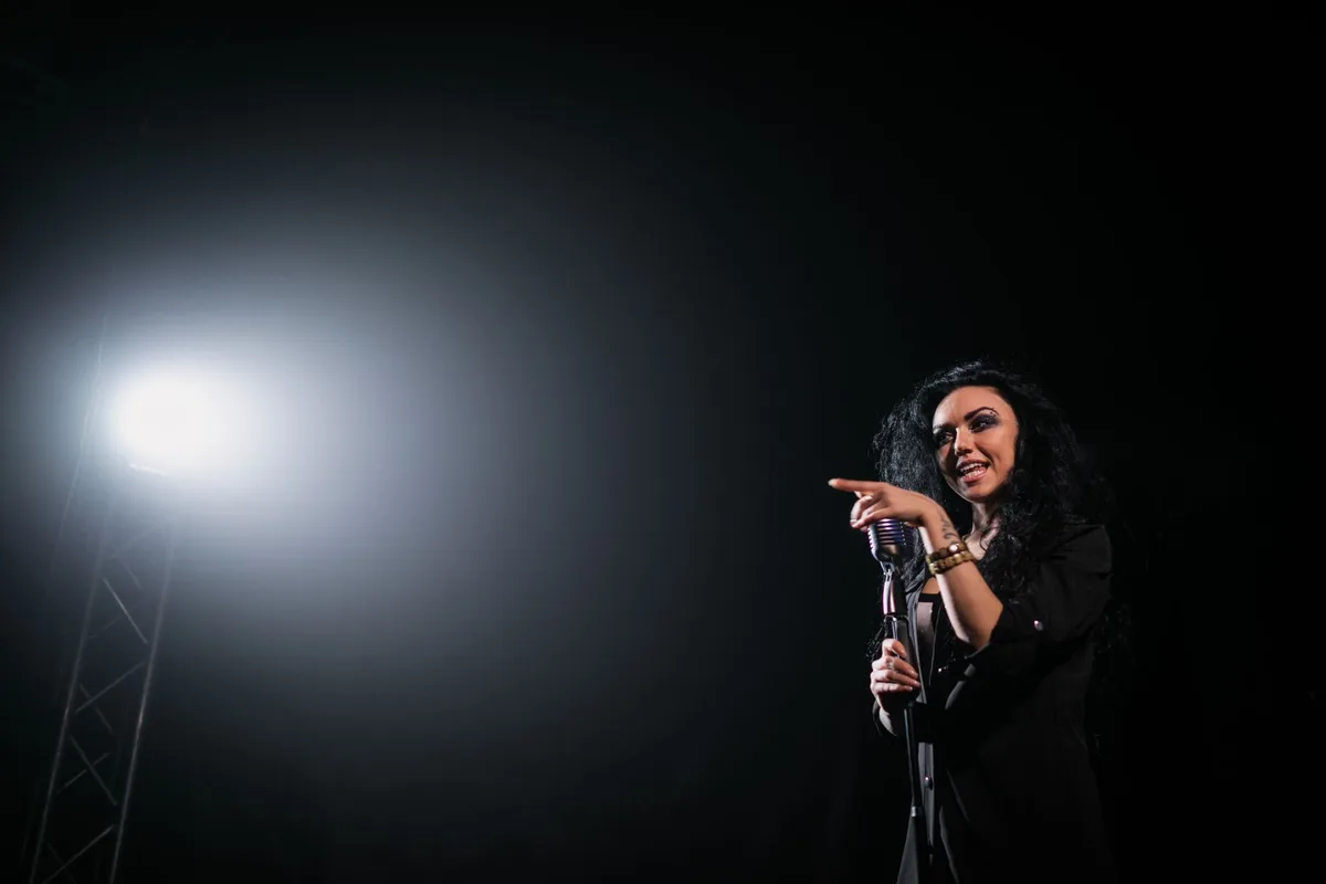 A microphone on an empty corporate stage under a single spotlight, with shadows stretching across polished marble, evoking silenced speech and power dynamics