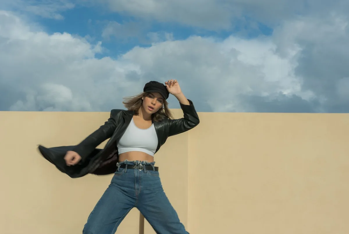 A leather hat and red-toned visual elements arranged artistically, symbolizing the album's aesthetic direction and thematic focus on love and self-discovery.