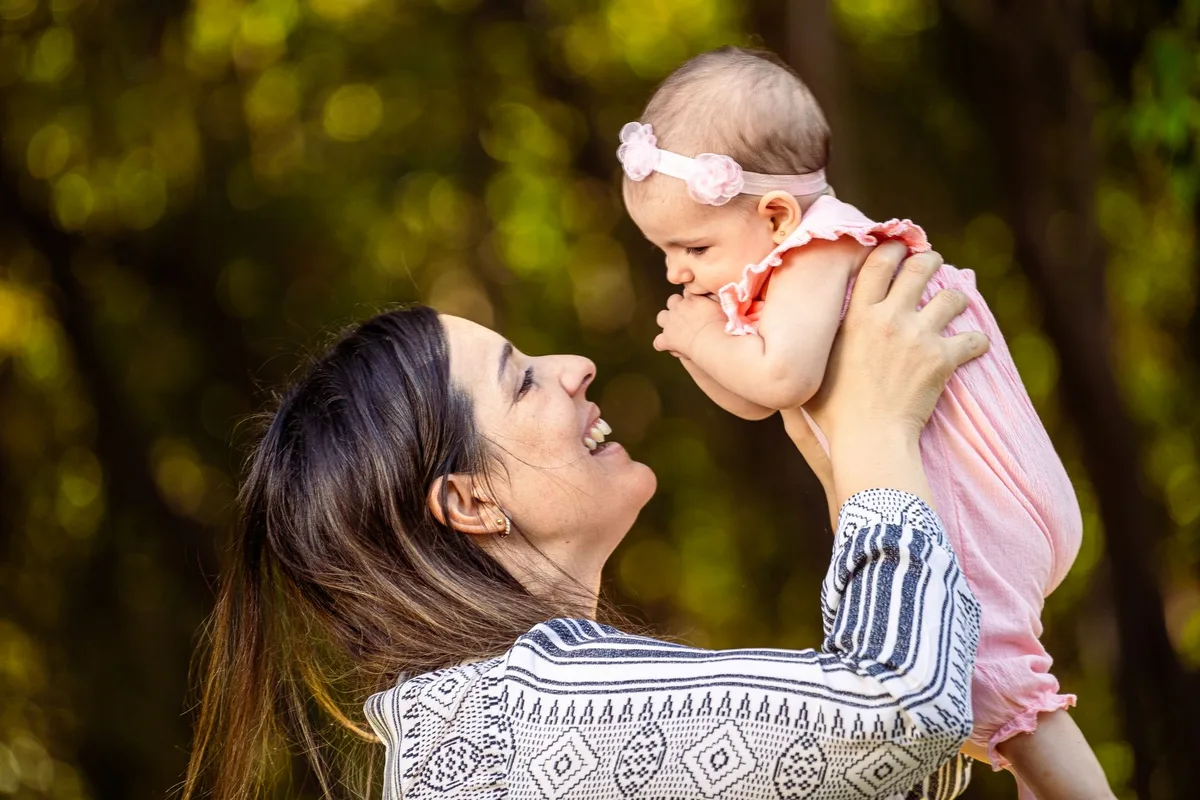 A mother and child in a hospital room, soft natural light filtering through a window, emotional moment captured in silence, hope amid uncertainty
