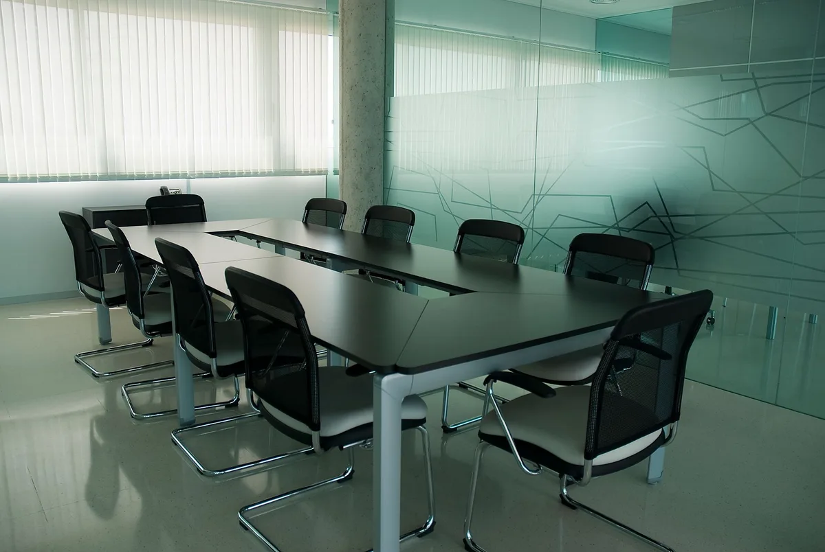 A sleek modern office or boardroom with an empty executive chair, soft lighting reflecting off polished surfaces, suggesting a shift in power and control