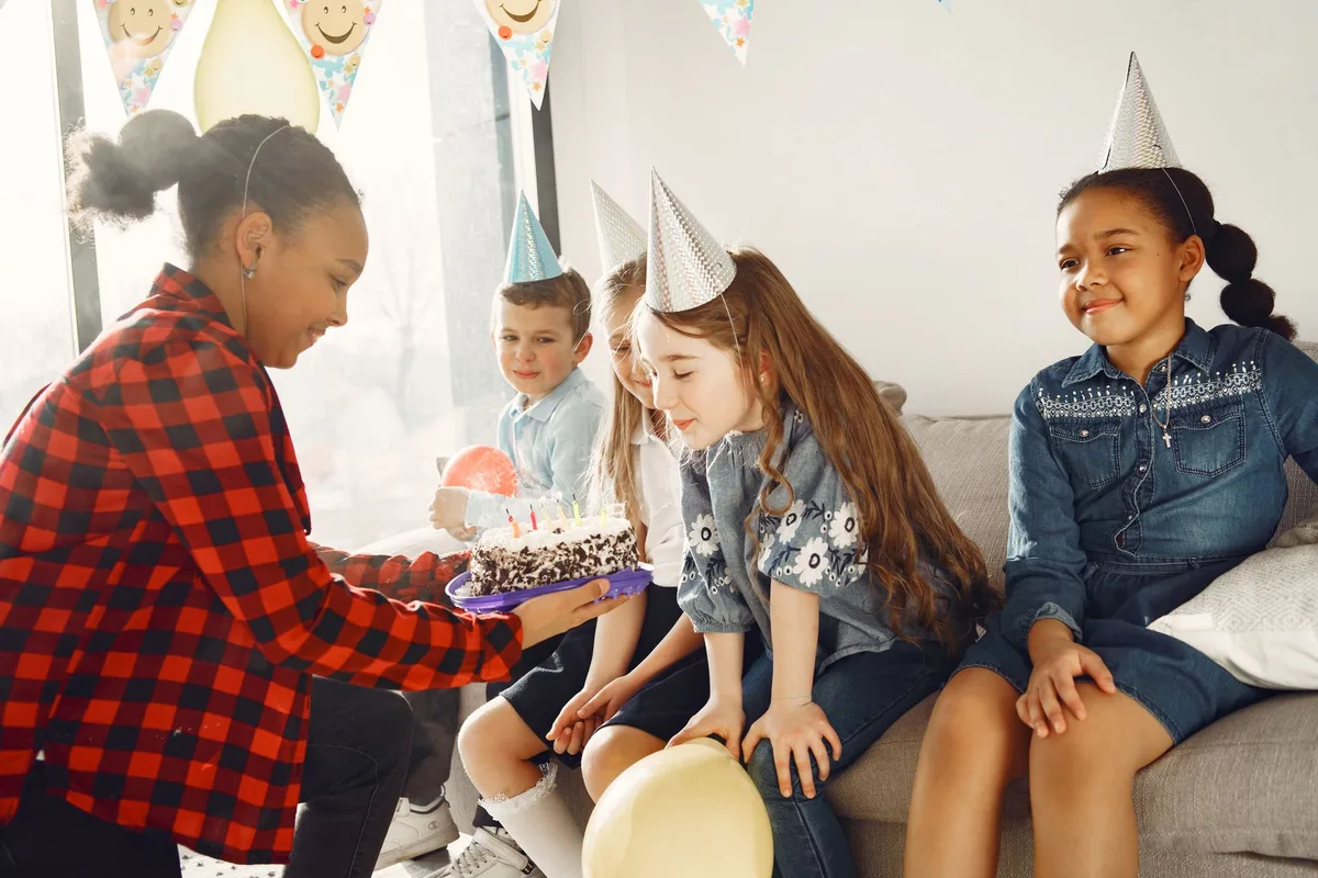 Elegant birthday party setting with tension in the air, family members in formal attire standing apart, decorations and cake visible, emotional distance between figures
