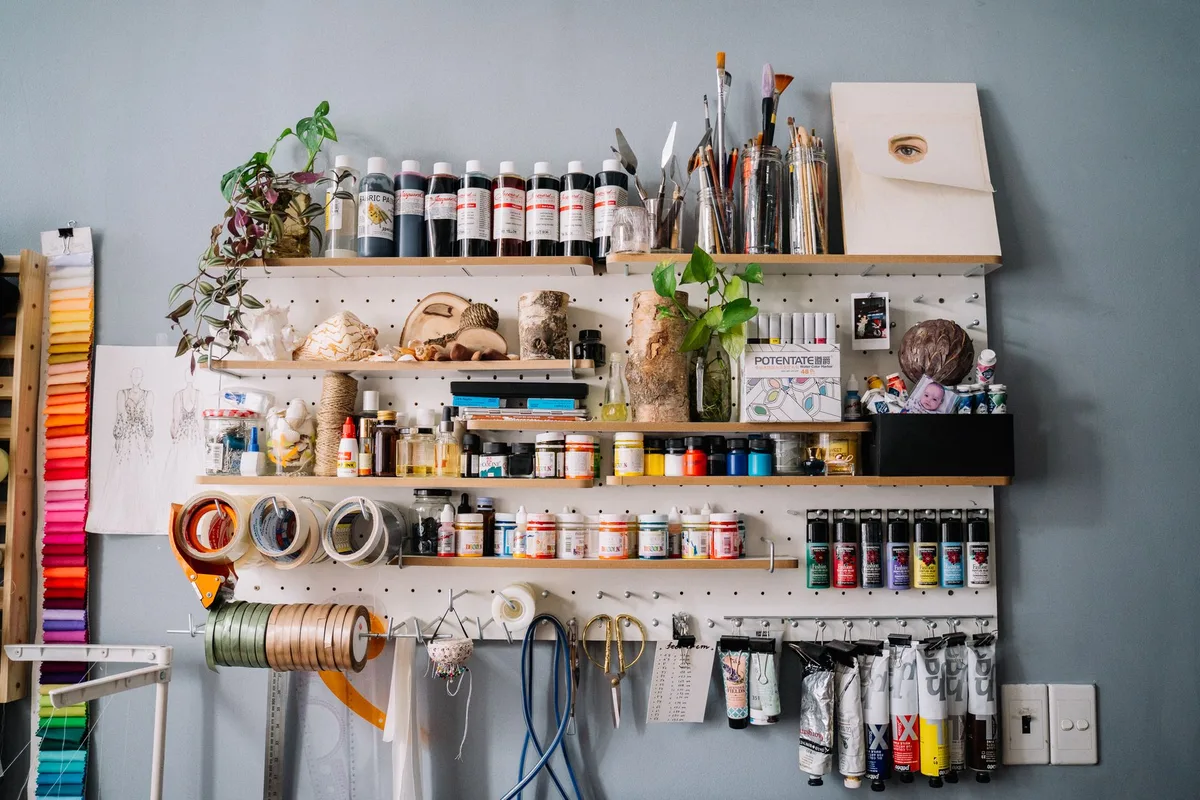 Artist's studio with polka dot patterns covering walls, canvases, and sculptural forms in vibrant colors, showing the obsessive repetition characteristic of her work