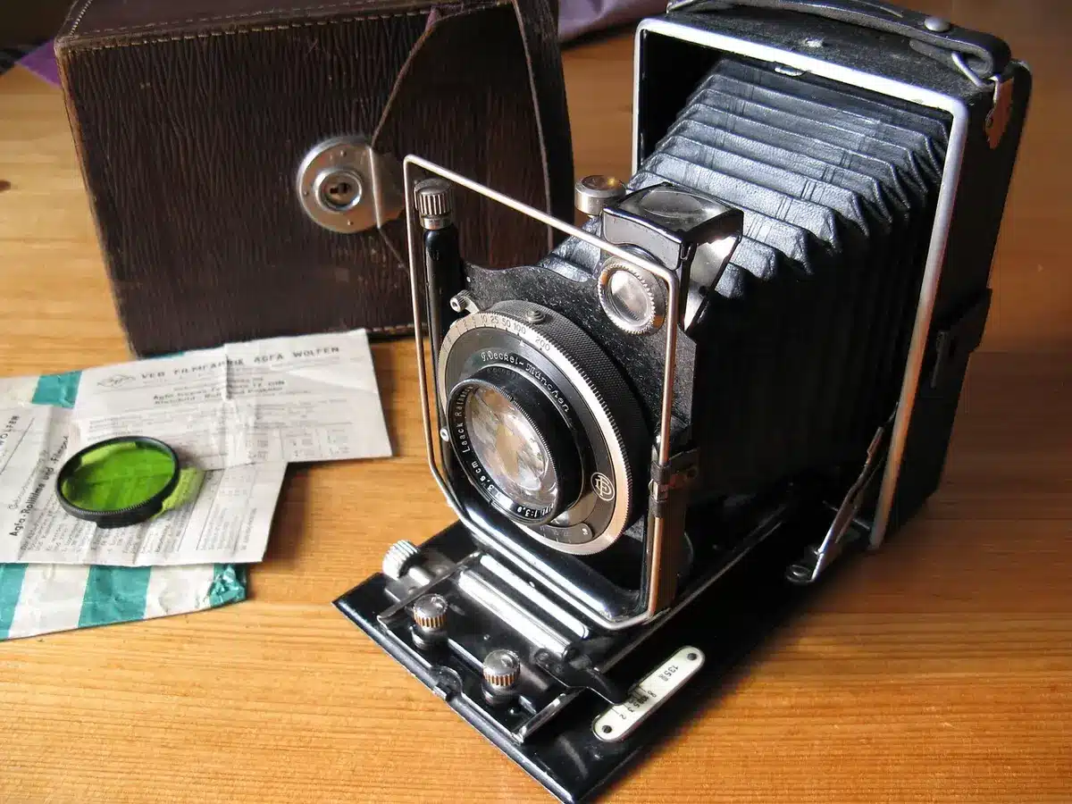 Wide empty photography studio with a single glass plate and developing tray on a table, soft overhead light