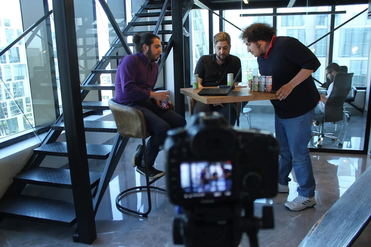 Behind-the-scenes film production setup with camera equipment, lighting rigs, and crew members in motion, cinematic atmosphere