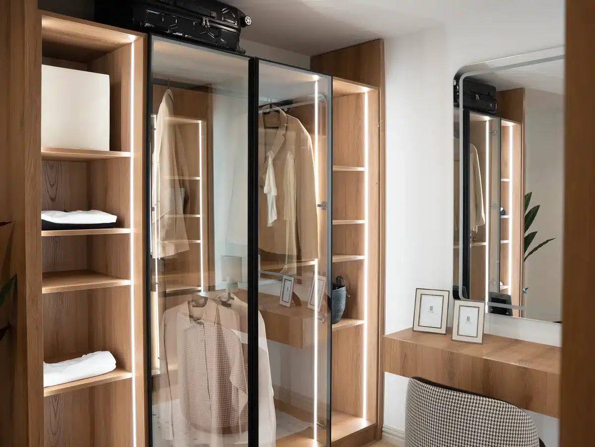 A single anonymous dressing-room scene with a plain vanity table, scattered makeup tools and a mirror reflecting a blurred silhouette; no logos or identifiable features