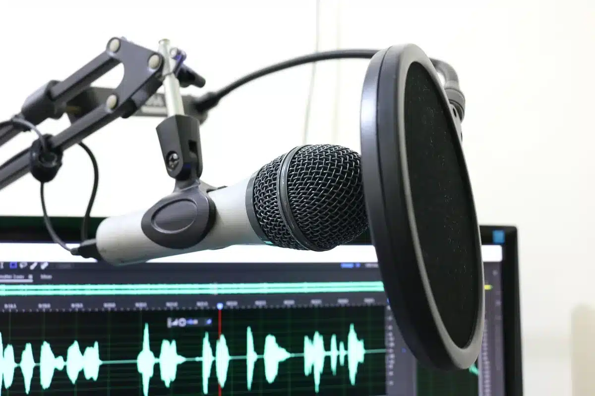 A recording studio with professional equipment, acoustic panels, and a microphone on a stand, bathed in warm studio lighting, representing the creative process of composing English-language country music