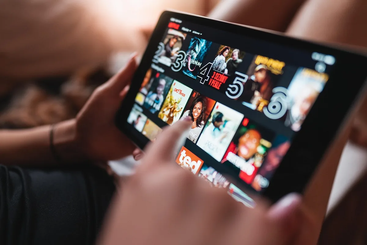A streaming service interface displaying multiple movie titles with view counts, showing the dynamic nature of Netflix's constantly updating top 10 rankings