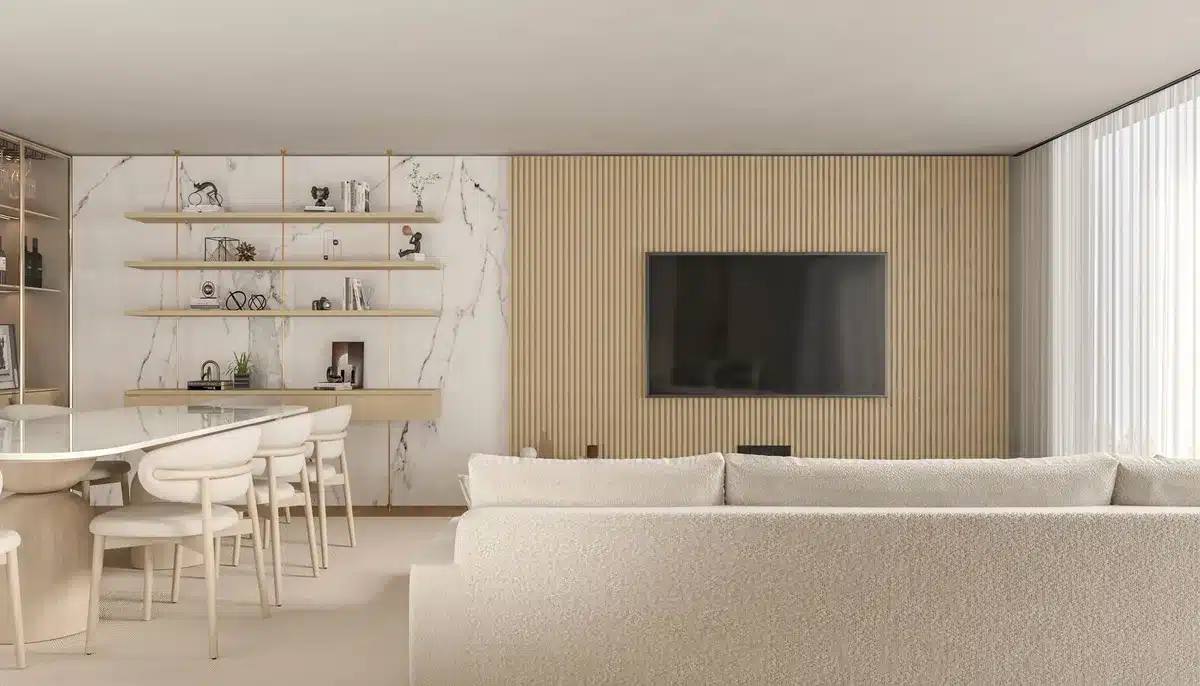 A wide shot of an empty modern living room with a large unbranded TV screen showing a paused generic football match menu; a remote on the couch and a coffee table with a mug