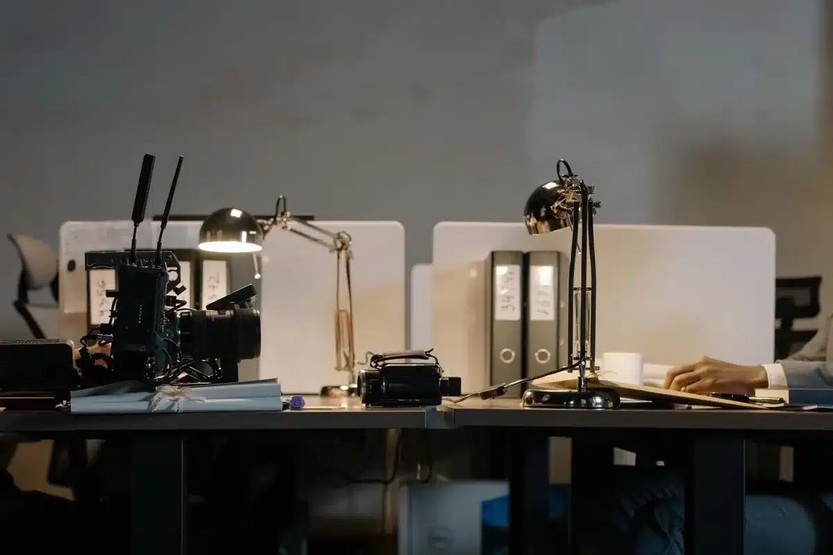 empty newsroom desk with scattered newspapers and a turned-off studio microphone